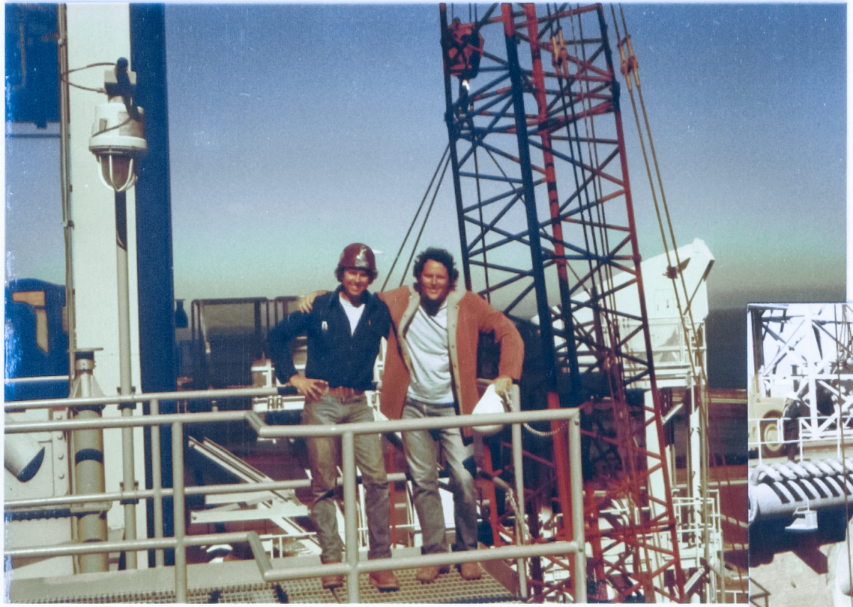 Steve Parker (left) and James MacLaren (right), standing on the 220' level crossover catwalk between the RSS and FSS, enjoy a lighter moment for a brief time during the lift and attachment of the Intertank Access Arm to the Fixed Service Structure at Space Shuttle Launch Complex 39-B, Kennedy Space Center, Florida.